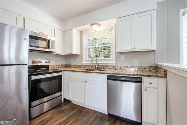 5052 Mountain St, Stone Mountain, GA 30083 - kitchen with white cabinetry, a sink, and stainless steel appliances