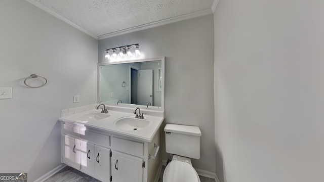 130 Fairview Dr, Stockbridge, GA 30281 - bathroom featuring double vanity, a sink, ornamental molding, and a textured ceiling