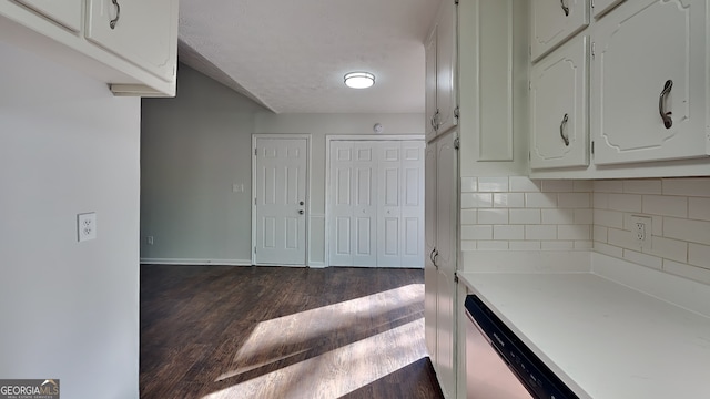 130 Fairview Dr, Stockbridge, GA 30281 - kitchen featuring dark wood-style floors, white cabinets, light countertops, tasteful backsplash, and dishwasher