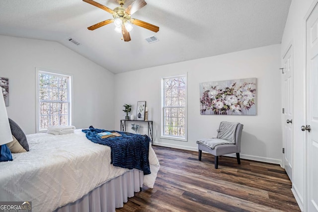 694 Austin Rd, Newnan, GA 30263 - bedroom featuring dark wood-type flooring, vaulted ceiling, a ceiling fan, and a textured ceiling