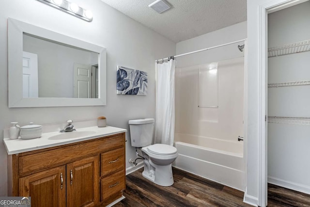 694 Austin Rd, Newnan, GA 30263 - bathroom with wood finished floors, vanity, a textured ceiling, and shower / bath combo