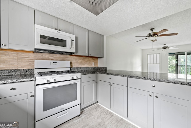 66 Fair Haven Way SE, Smyrna, GA 30080 - kitchen featuring white appliances, a textured ceiling, visible vents, and gray cabinets