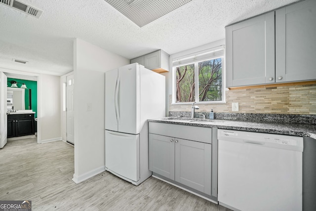 66 Fair Haven Way SE, Smyrna, GA 30080 - half bath featuring vanity, toilet, a textured ceiling, baseboards, and wood finished floors