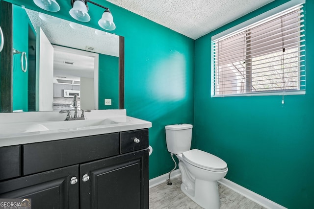 66 Fair Haven Way SE, Smyrna, GA 30080 - unfurnished living room with ceiling fan, a textured ceiling, baseboards, a fireplace with flush hearth, and wood finished floors