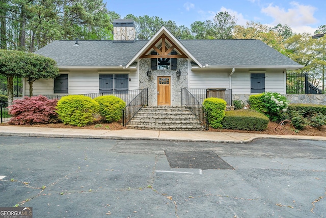 66 Fair Haven Way SE, Smyrna, GA 30080 - view of front of house featuring a chimney, a shingled roof, and stone siding