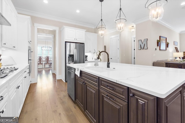 432 Horizon Trl, Canton, GA 30114 - kitchen with stainless steel appliances, dark brown cabinets, a sink, white cabinets, and wall chimney range hood