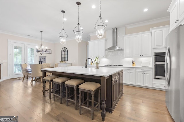 432 Horizon Trl, Canton, GA 30114 - kitchen featuring wall chimney range hood, appliances with stainless steel finishes, light countertops, a breakfast bar area, and ornamental molding