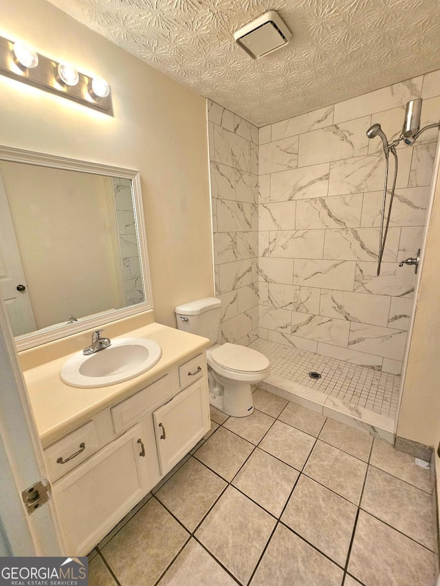 1557 Springleaf Ct SE, Smyrna, GA 30080 - full bath featuring a stall shower, a textured ceiling, toilet, and vanity