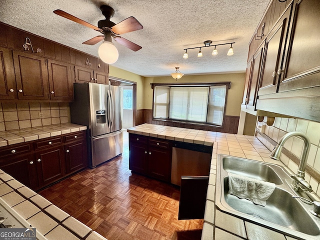 839 Golf Dr, Swainsboro, GA 30401 - kitchen featuring tile counters, stainless steel refrigerator with ice dispenser, a sink, and a ceiling fan