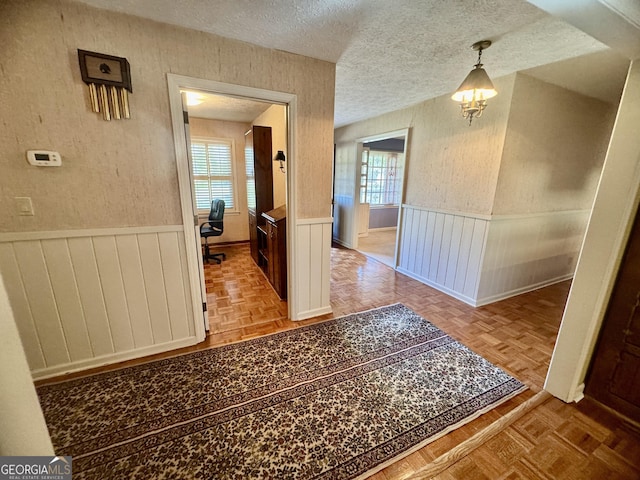 839 Golf Dr, Swainsboro, GA 30401 - hallway with a wainscoted wall and a textured ceiling