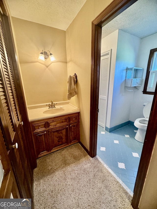 839 Golf Dr, Swainsboro, GA 30401 - bathroom featuring toilet, a textured ceiling, baseboards, and vanity