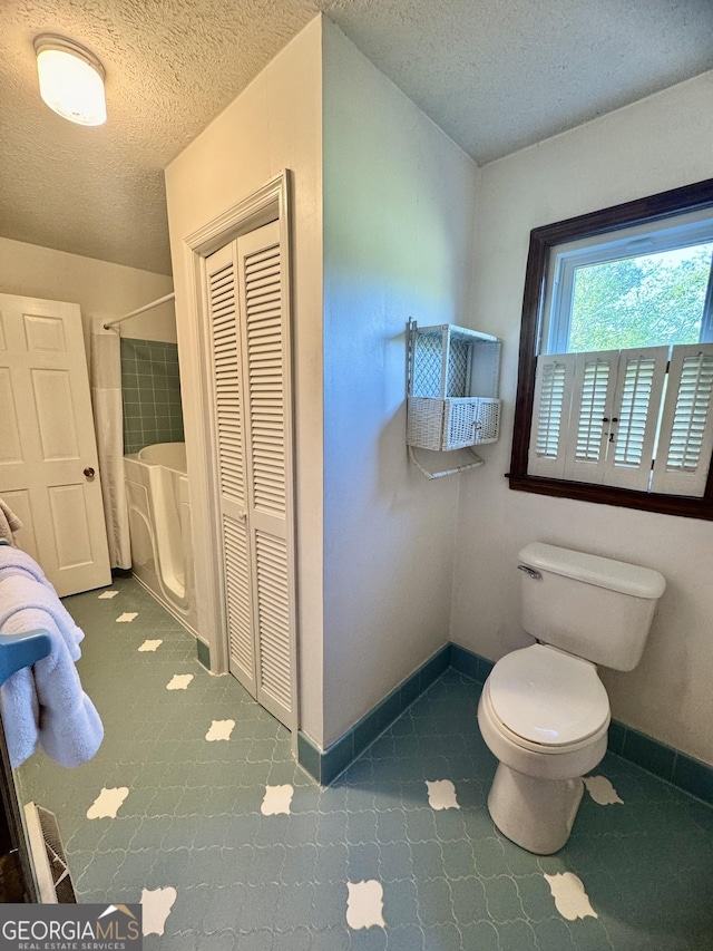 839 Golf Dr, Swainsboro, GA 30401 - full bathroom with a closet, a textured ceiling, baseboards, and toilet