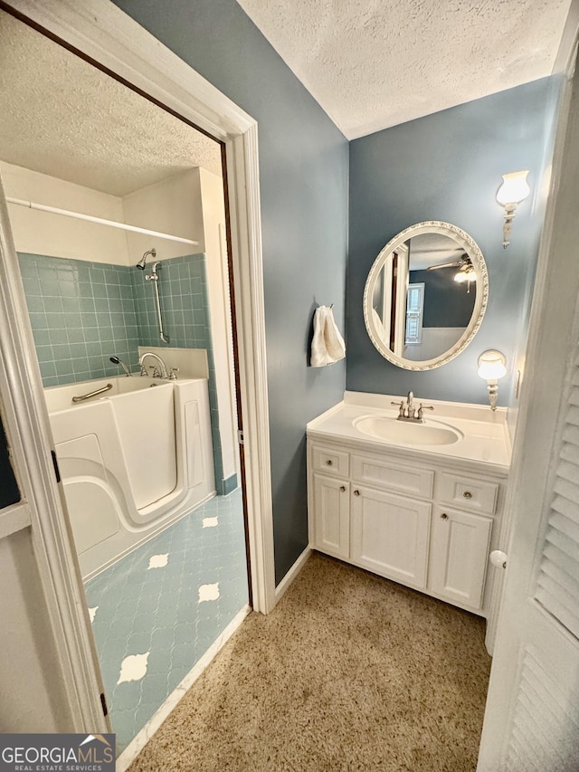 839 Golf Dr, Swainsboro, GA 30401 - bathroom with vanity, a textured ceiling, baseboards, and a washtub