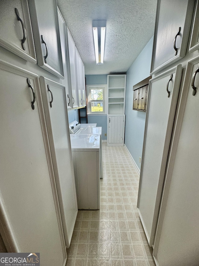 839 Golf Dr, Swainsboro, GA 30401 - washroom with cabinet space, a textured ceiling, baseboards, light floors, and washer and clothes dryer