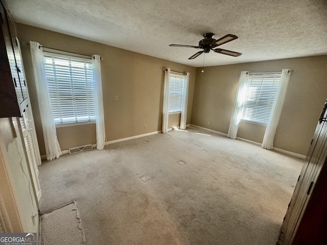 839 Golf Dr, Swainsboro, GA 30401 - carpeted spare room featuring baseboards, ceiling fan, a textured ceiling, and visible vents