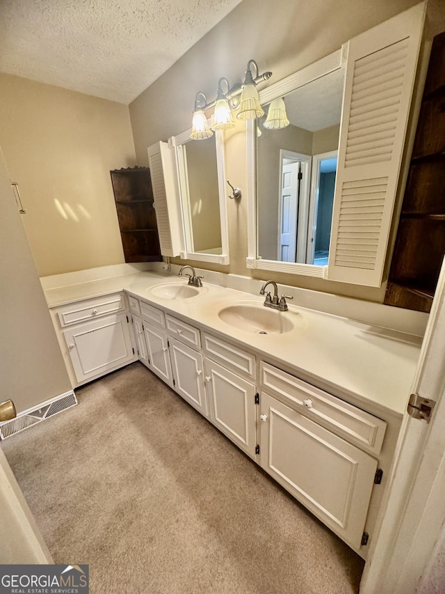 839 Golf Dr, Swainsboro, GA 30401 - bathroom with vanity, carpet, a textured ceiling, and visible vents