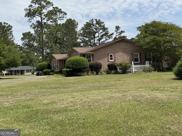 839 Golf Dr, Swainsboro, GA 30401 - view of property exterior with a lawn and brick siding