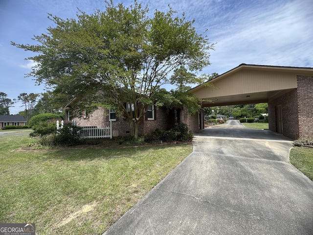 839 Golf Dr, Swainsboro, GA 30401 - ranch-style house featuring an attached carport, concrete driveway, brick siding, and a front yard