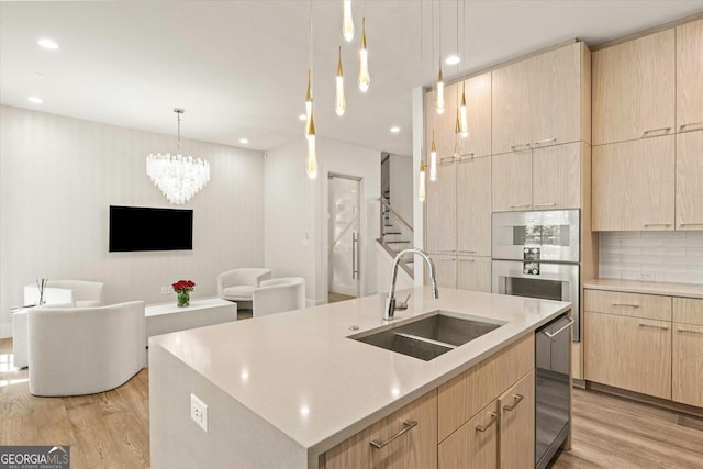 1337 Grey Fox Ct NE Unit 7, Atlanta, GA 30306 - kitchen featuring light countertops, light brown cabinetry, light wood-style flooring, and a sink