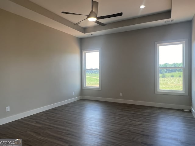 1502 Whooping Creek Church Rd, Carrollton, GA 30117 - spare room with ceiling fan, a tray ceiling, dark wood-style floors, and visible vents