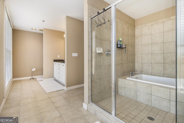 1133 Church Unit 1, Covington, GA 30014 - bathroom featuring tile patterned flooring, a shower stall, vanity, and tiled bath
