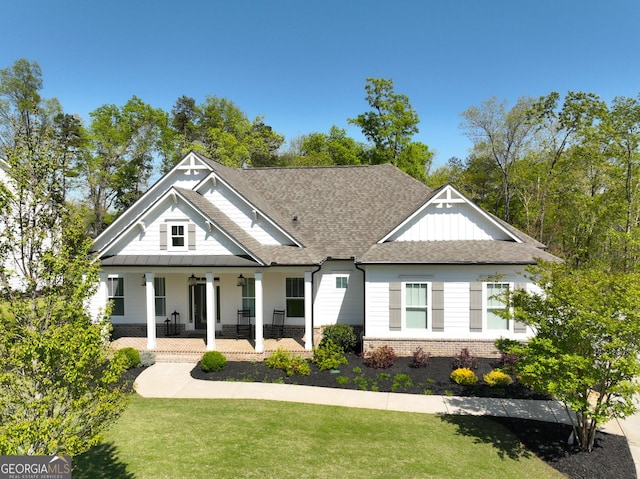305 Red Gate Ln, Canton, GA 30115 - view of front of home with brick siding, a porch, a shingled roof, and a front lawn