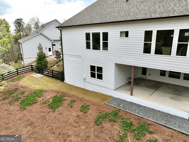 305 Red Gate Ln, Canton, GA 30115 - back of property featuring a patio area, a yard, fence, and a shingled roof