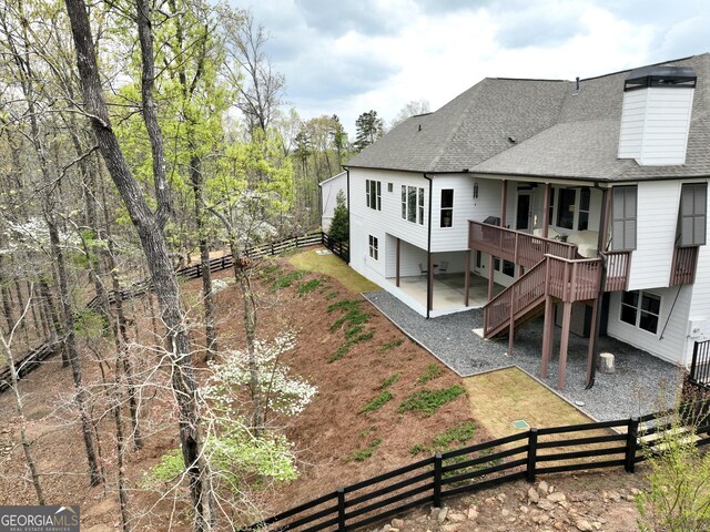305 Red Gate Ln, Canton, GA 30115 - rear view of property featuring a patio, a shingled roof, a fenced backyard, and stairway