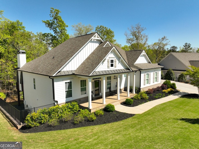 305 Red Gate Ln, Canton, GA 30115 - back of property featuring a standing seam roof, a shingled roof, fence, and a lawn