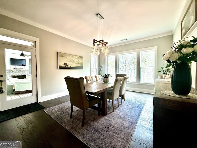 305 Red Gate Ln, Canton, GA 30115 - dining room featuring crown molding, an inviting chandelier, dark wood-type flooring, visible vents, and baseboards