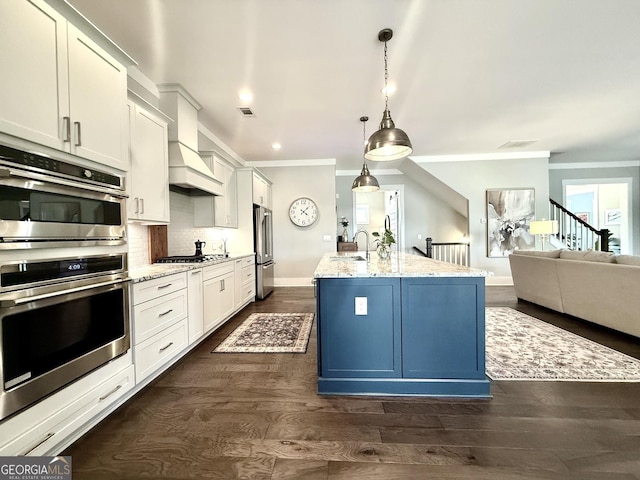 305 Red Gate Ln, Canton, GA 30115 - kitchen featuring open floor plan, crown molding, light stone countertops, stainless steel appliances, and a sink