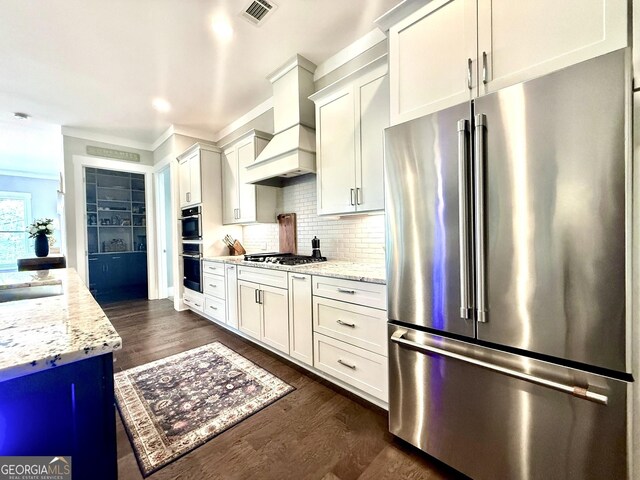 305 Red Gate Ln, Canton, GA 30115 - kitchen with tasteful backsplash, visible vents, dark wood-style flooring, stainless steel appliances, and custom range hood