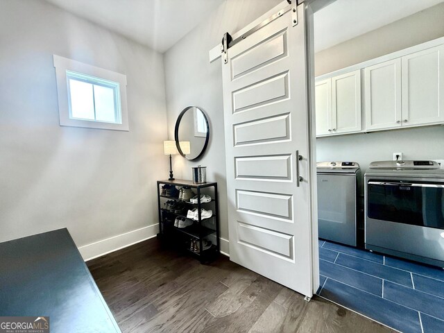 305 Red Gate Ln, Canton, GA 30115 - laundry area featuring baseboards, dark wood finished floors, a barn door, independent washer and dryer, and cabinet space
