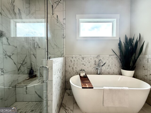 305 Red Gate Ln, Canton, GA 30115 - bathroom featuring tile walls, a soaking tub, a shower stall, wainscoting, and marble finish floor