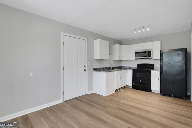 944 Joseph E Boone Blvd NW, Atlanta, GA 30314 - kitchen with light wood-style floors, white cabinets, black appliances, dark stone countertops, and a sink
