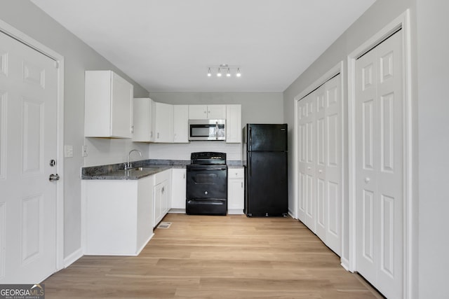 944 Joseph E Boone Blvd NW, Atlanta, GA 30314 - kitchen featuring dark stone countertops, white cabinets, black appliances, light wood-style floors, and a sink