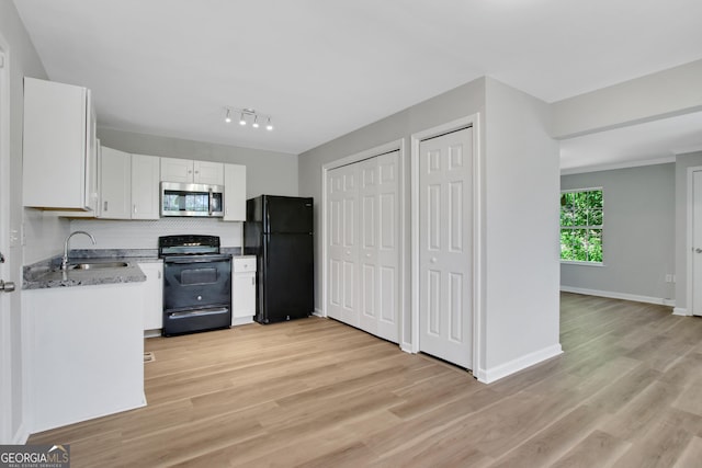 944 Joseph E Boone Blvd NW, Atlanta, GA 30314 - kitchen featuring white cabinets, a sink, light wood-type flooring, black appliances, and decorative backsplash