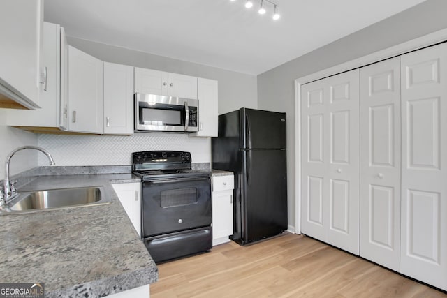 944 Joseph E Boone Blvd NW, Atlanta, GA 30314 - kitchen with light wood-style floors, white cabinetry, black appliances, a sink, and decorative backsplash
