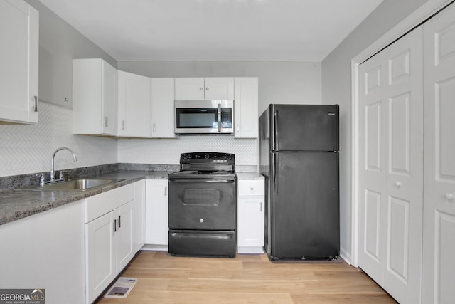 944 Joseph E Boone Blvd NW, Atlanta, GA 30314 - kitchen with tasteful backsplash, visible vents, a sink, black appliances, and white cabinetry