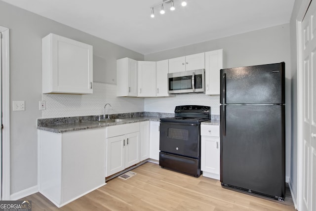 944 Joseph E Boone Blvd NW, Atlanta, GA 30314 - kitchen with white cabinets, visible vents, a sink, and black appliances
