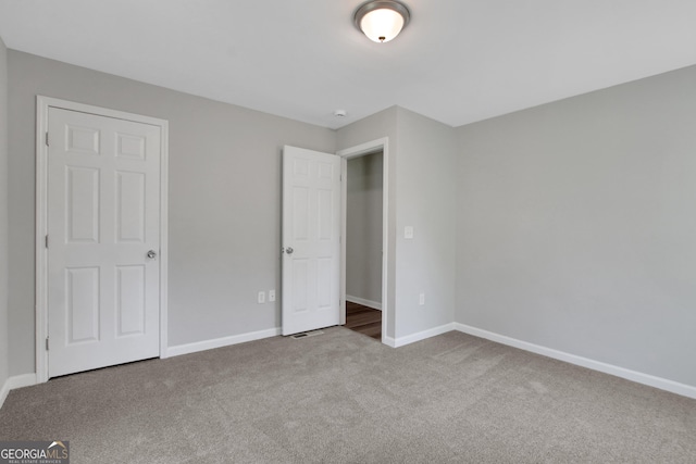 944 Joseph E Boone Blvd NW, Atlanta, GA 30314 - unfurnished bedroom featuring baseboards and carpet floors