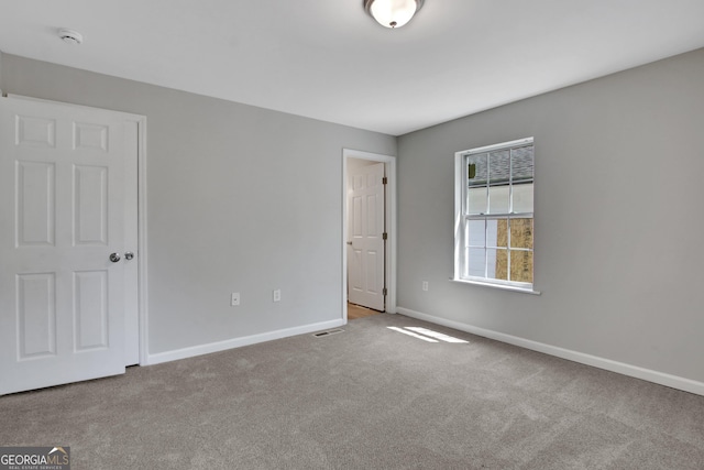 944 Joseph E Boone Blvd NW, Atlanta, GA 30314 - unfurnished bedroom with carpet flooring, visible vents, and baseboards