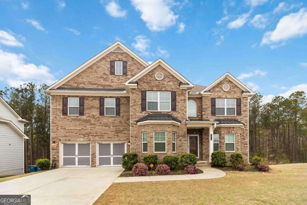 3478 Spring Place Ct, Loganville, GA 30052 - view of front of house featuring a front yard, an attached garage, brick siding, and concrete driveway