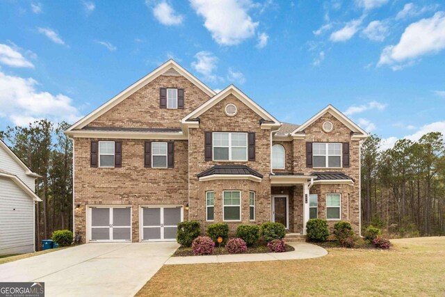 3478 Spring Place Ct, Loganville, GA 30052 - view of front of house featuring a front yard, an attached garage, brick siding, and concrete driveway