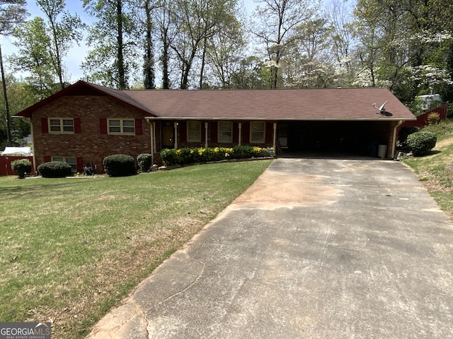 ranch-style house with concrete driveway, brick siding, a front yard, and an attached carport