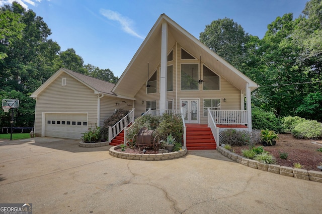 view of front of property featuring stairs, french doors, a ceiling fan, concrete driveway, and a garage
