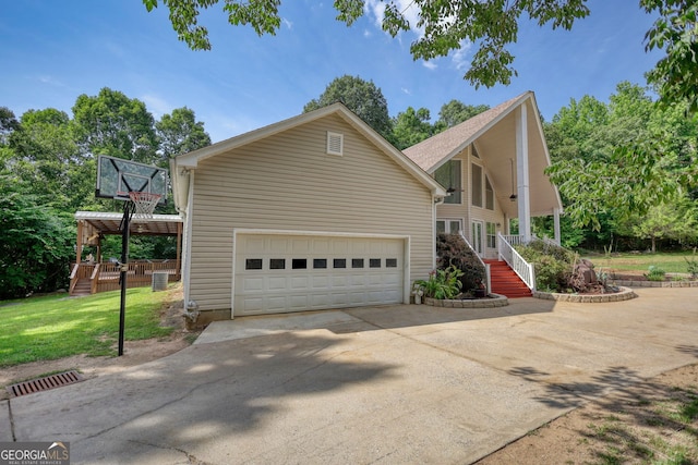 view of home's exterior with driveway, a garage, and a lawn
