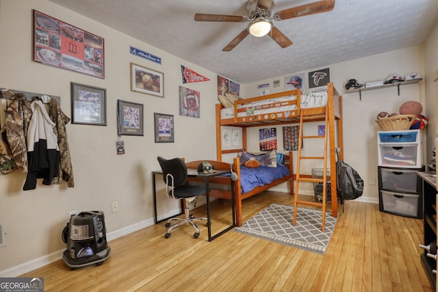 bedroom featuring hardwood / wood-style flooring and baseboards
