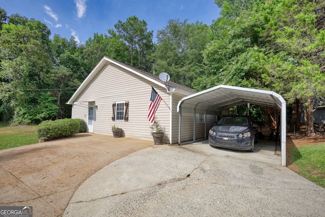 view of side of property with driveway and a carport