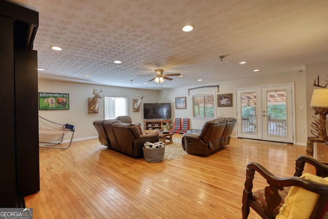 living room with baseboards, recessed lighting, a ceiling fan, and wood-type flooring